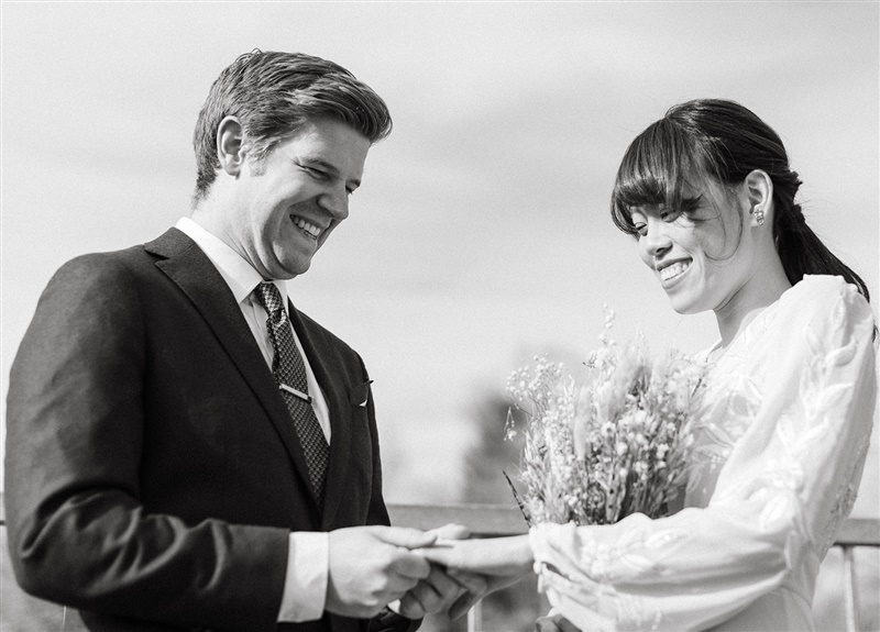 Wedding day couple about to exchange rings at Carleton Place Bridge